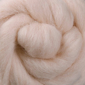 A close-up of a spiral of Ashford Handicrafts Limited's Corriedale New Zealand Wool Fiber, displaying a soft, pale pink hue. The fluffy and smooth texture is excellent for spinning or crafting, and its pastel shade imparts a gentle and warm appearance, perfect as felting wool.