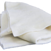 A folded, cream-colored wool Merino Prefelt from Europa Wools Ltd lies against a plain white background. The texture appears soft and slightly thick, suggesting warmth and comfort. With natural, slightly uneven edges hinting at handcrafted quality, this Merino Prefelt is perfect for nuno felting projects or adding touches to other creations.