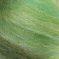 Close-up of fluffy, fibrous green strands from the Merino Silk Top Fiber by Europa Wools Ltd, showcasing subtle variations in shades of green and light reflections.