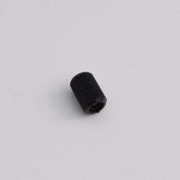 A small, black cylindrical object with a ribbed texture, identified as the Louët Brake Tension Nut by Louët Inc., placed against a plain white background. The hollow cylinder has an open end visible and is likely intended as a replacement component for a Louët wheel.