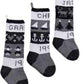 The Classic Christmas Stockings from Yankee Knitter Designs feature three individualized grayscale stockings, each beautifully adorned with unique patterns such as hearts, trees, anchors, sailboats, and reindeers. Handcrafted from worsted weight yarn, these traditional keepsakes are personalized with the names "GRAN," "CHAR," and "JAR," along with the partially visible year "199.