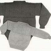 Displayed are two Guilford Guernsey sweaters by Yankee Knitter Designs. One is larger and dark gray, the other smaller and light gray. Both feature a classic sweater design with a detailed chevron pattern using knit and purl stitches on the upper sections, showcasing the timeless guernsey yoke style.