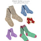 A selection of Yankee Knitter Designs' Classic Socks, available for download, in various sizes and colors: large gray, medium blue, small red with white toes and heels, tiny purple, and green with pink toes and heels. The text above reads "Classic Socks for the family: fingering ♥ sport ♥ worsted," offering different yarn weights and sizes from baby to adult.