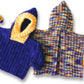 Two vibrant, knitted hooded baby jackets from Bryson Distributing, Inc. are displayed next to one another. One is predominantly blue with a yellow-lined hood and an easy garter rib pattern, titled the Back Zip Baby Jacket. The other jacket features a multicolored design and includes a convenient back zipper. Small, multi-colored balls are placed beside each jacket for added charm.