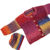 The Flared Baby Jacket and Hat by Plymouth Yarn Co features a hand-knitted baby sweater and matching knit hat in a stunning gradient pattern showcasing shades of red, pink, orange, yellow, and blue. Made from worsted weight yarn, the sweater is designed with four wooden buttons and long sleeves. The coordinating rounded, ribbed hat mirrors the same vibrant gradient.