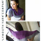 Two images of a woman showcasing a purple and gray crescent-shaped Linaza 2 Color Shawl from Plymouth Yarn Co. The top image shows her wearing the shawl draped around her shoulders, highlighting its lace border, while the bottom image displays the full spread of the lightweight yarn shawl as she holds it out.