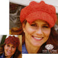 A woman smiles as she dons a textured red knit cap from the "Newsie Cap, Knit or Crochet Pattern" collection by Knit One, Crochet Too. An inset displays her in a similar crochet cap featuring a small visor, with the brand's logo visible in the corner.