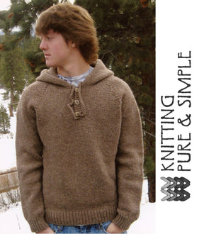 A person with medium-length hair is standing outdoors, wearing the Neck Down Men's Hooded Pullover by Bryson Distributing, Inc., which features a brown knit design and a buttoned collar. The background showcases snow-covered ground and pine trees. To the right, text reads "KNITTING PURE & SIMPLE," accompanied by a small knitting graphic.