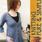 A woman with shoulder-length auburn hair wears the Neck Down Swing Cardigan, a long, blue, buttoned garment from Bryson Distributing, Inc., over a black top. She stands next to a coffee machine, twisting a knob. Text on the right reads "Knitting Pure & Simple" next to a colorful knitted pattern illustration featuring all-season wear designs.