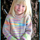 A young child with blonde hair and a colorful striped Child's Neck Down Pullover from Bryson Distributing, Inc. stands smiling in front of a large tree trunk. The sweater, featuring shades of pastel colors and a delicate cable pattern, suggests it’s a cool day outdoors.