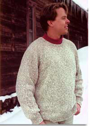 A man stands in the snow, facing to the right and smiling. He is wearing a thick, light gray Neck Down Pullover by Bryson Distributing, Inc., over a red high-neck shirt. In the background is a wooden structure with icicles hanging from the roof.