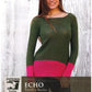 A woman stands against a wooden wall, wearing the "Echo Tunic" by Knitting Fever / Euro Yarns. This color-blocked, long-sleeve green tunic with a wide pink band at the bottom is perfect for intermediate knitters. The Juniper Moon Farm logo is visible in the image.