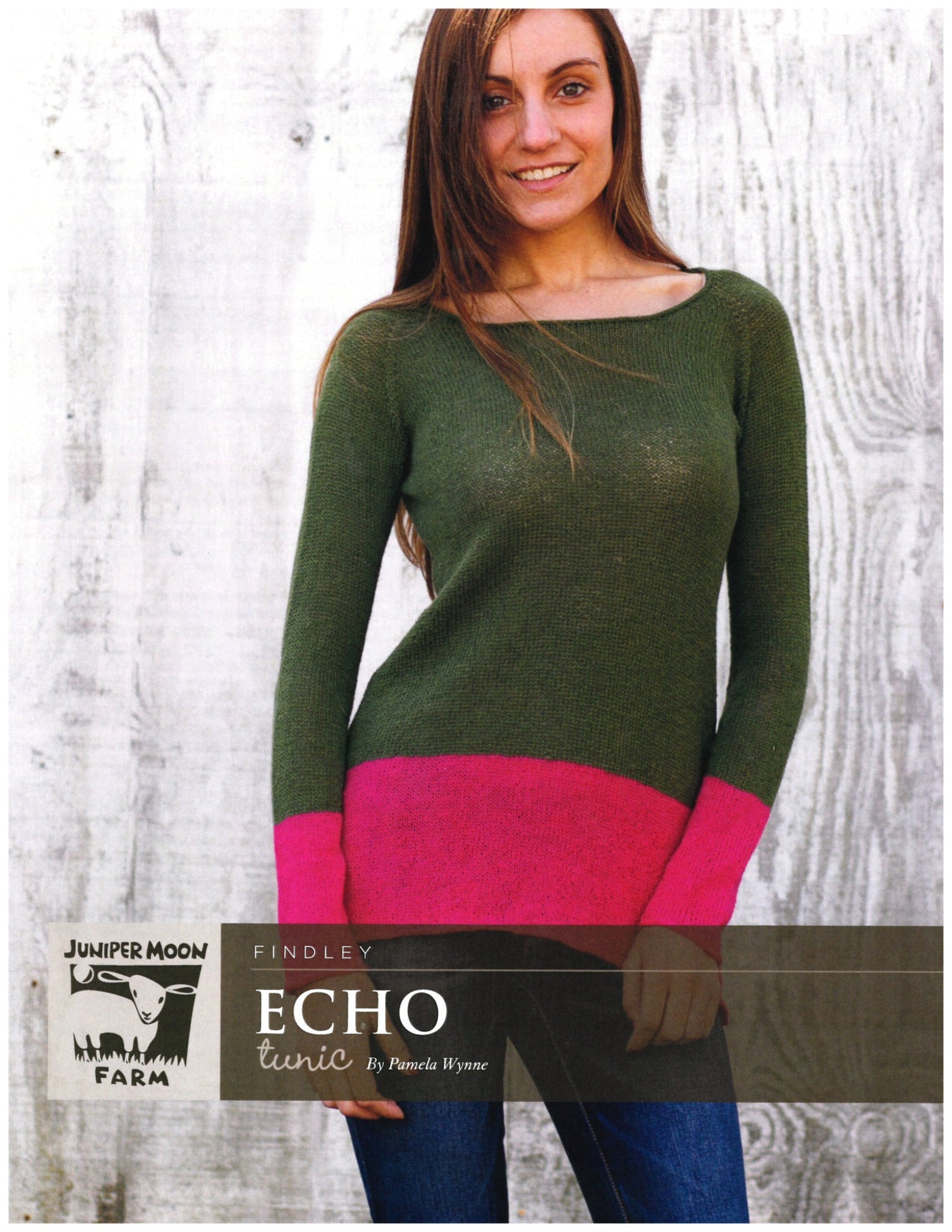 A person wearing a green tunic with a pink hem stands against a white wooden wall. The label reads "Knitting Fever / Euro Yarns" and "Echo Tunic Pattern," designed for intermediate knitters who appreciate the elegance of an i-cord bind off in their color-blocked tunic sweater creations.