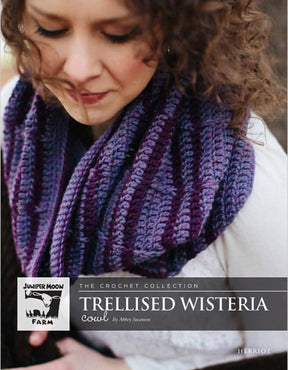 A close-up of a person wearing a stripey slouchy crochet cowl from "Knitting Fever / Euro Yarns." The text on the image reads: "The Crochet Collection Trellised Wisteria Cowl by Aubrey Swanson" and "Herriot Trellised Wisteria Crochet Cowl." Made with Juniper Moon Herriot Alpaca, the person appears to be looking down.