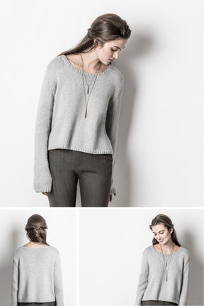 In the top photo, a woman is wearing a light grey Spring Hill Sweater from Blue Sky Fibers, made with organic cotton worsted yarn, paired with dark grey pants as she looks down. Below it are two smaller photos: one displaying the back of her outfit and another showing a side view of her looking down. Her long hair is tied at the back.