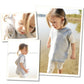 A child with light hair is wearing a handknit "Cameron Hoodie" from Blue Sky Fibers paired with white pants. They are depicted in three photos: a close-up, a side view walking on the beach, and a wider shot standing near water with tall grass in the background.