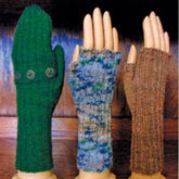 Three mannequin hands display Lisa's Knits Fingerless Gloves and Mitts, Fingering Weight: the left hand shows a long green mitten with buttons, the middle hand has a blue and white fingerless glove, and the right hand features a brown fingerless mitt with a textured pattern, all against a wooden background.