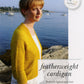 A person stands outdoors by a body of water, wearing a yellow Knitbot Featherweight Cardigan over a white dress. The text on the image reads: "Never Not Knitting presents the Knitbot Featherweight Cardigan: Perfectly lightweight knit in your favorite lace or fingering weight yarn.