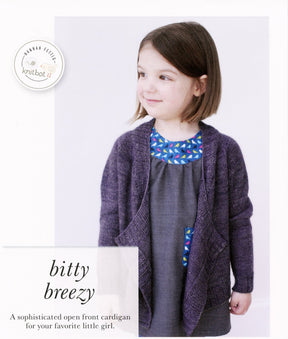 A young girl, the sophisticated little one, is wearing the stylish Knitbot Bitty Breezy Cardigan in dark purple from Never Not Knitting over a gray dress adorned with a colorful bird pattern on the neckline and pocket. She is looking to the side and smiling. The image includes the text "bitty breezy" and describes the cardigan.