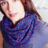 A person wearing a Garter Stitch Rib Cowl made from Ella Rae Lace Merino is shown with long brown hair and a gray top, with "Knitting Fever / Euro Yarns" noted in the top right corner.