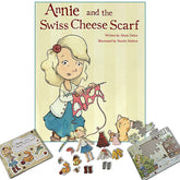 The image features the "Annie and the Swiss Cheese Scarf: Deluxe Gift Set" by Never Not Knitting, authored by Alana Dakos and illustrated by Neesha Hudson. Surrounding the gift set are related items including a children's puzzle, paper dolls, and various cut-out accessories like clothing and tools.