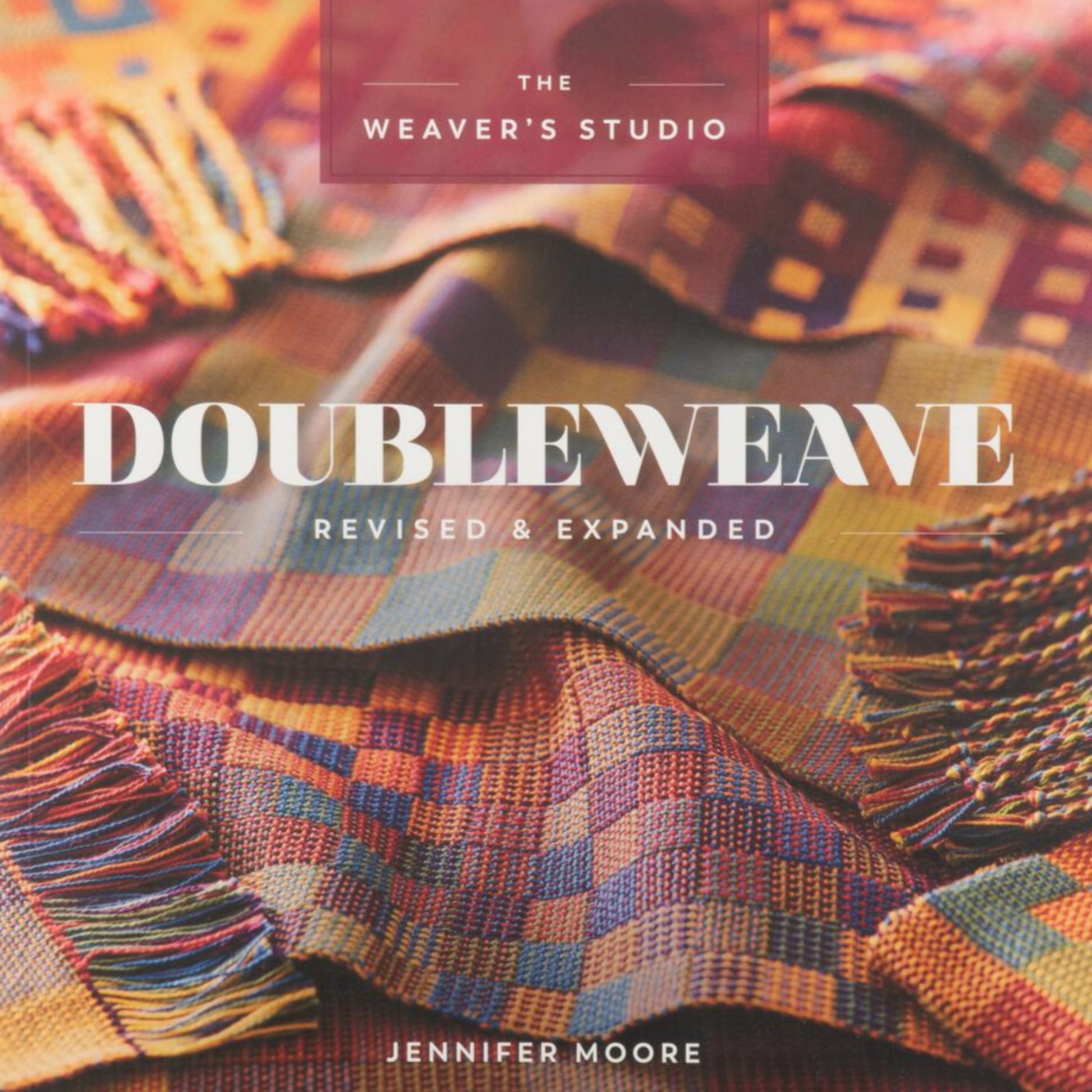 A vibrant book cover from Penguin Random House for "Doubleweave Revised & Expanded" features colorful woven fabric patterns, showcasing the intricacies of a four-shaft loom. The title is prominently displayed in white text, with the subtitle and Jennifer Moore's name in smaller print below.