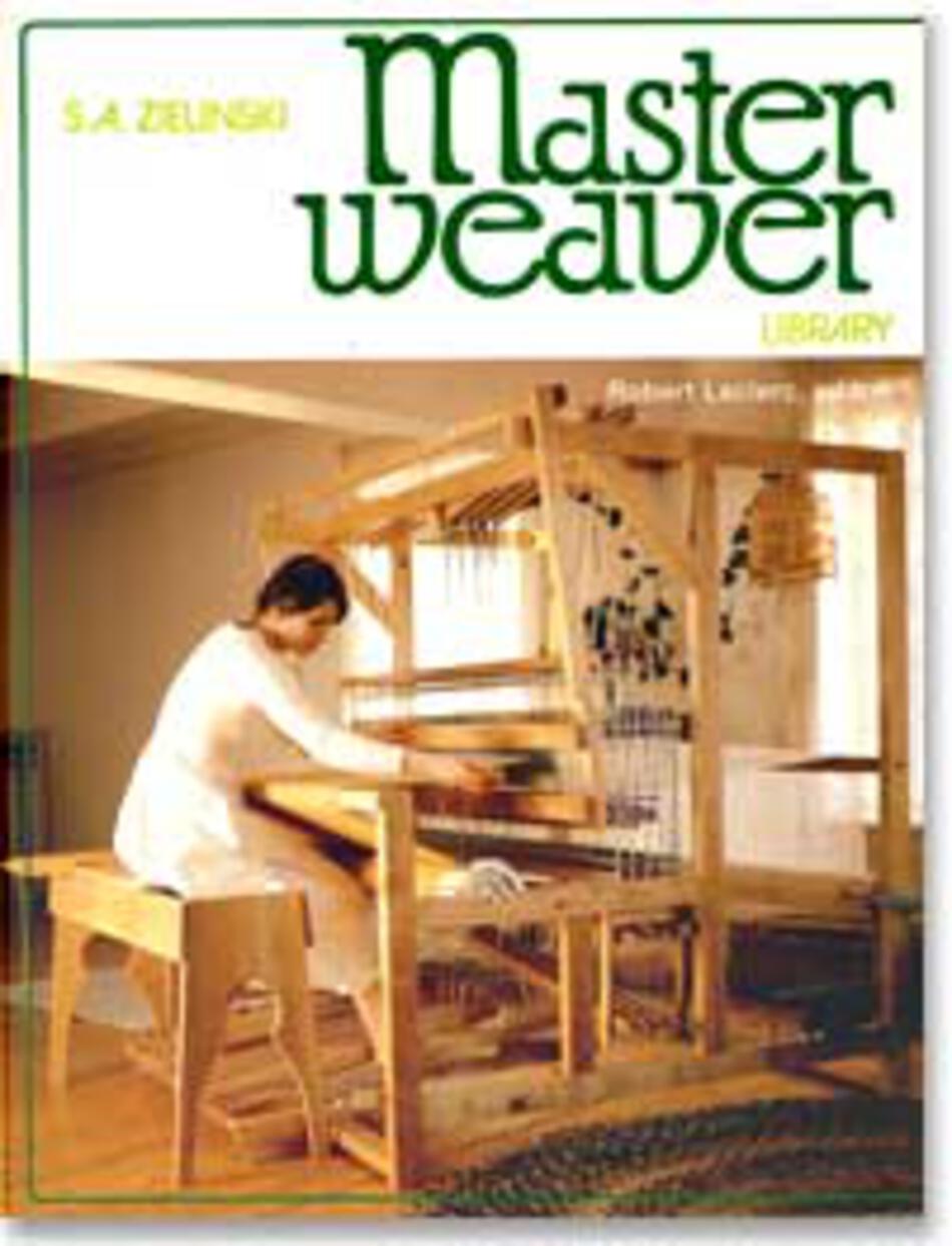 A person dressed in a white outfit is seated at a large wooden Leclerc loom. The spacious, well-lit background features various woven materials hanging. The text "S.A. Zielinski" and "The Master Weaver Library by Leclerc Looms" is displayed at the top of the image.
