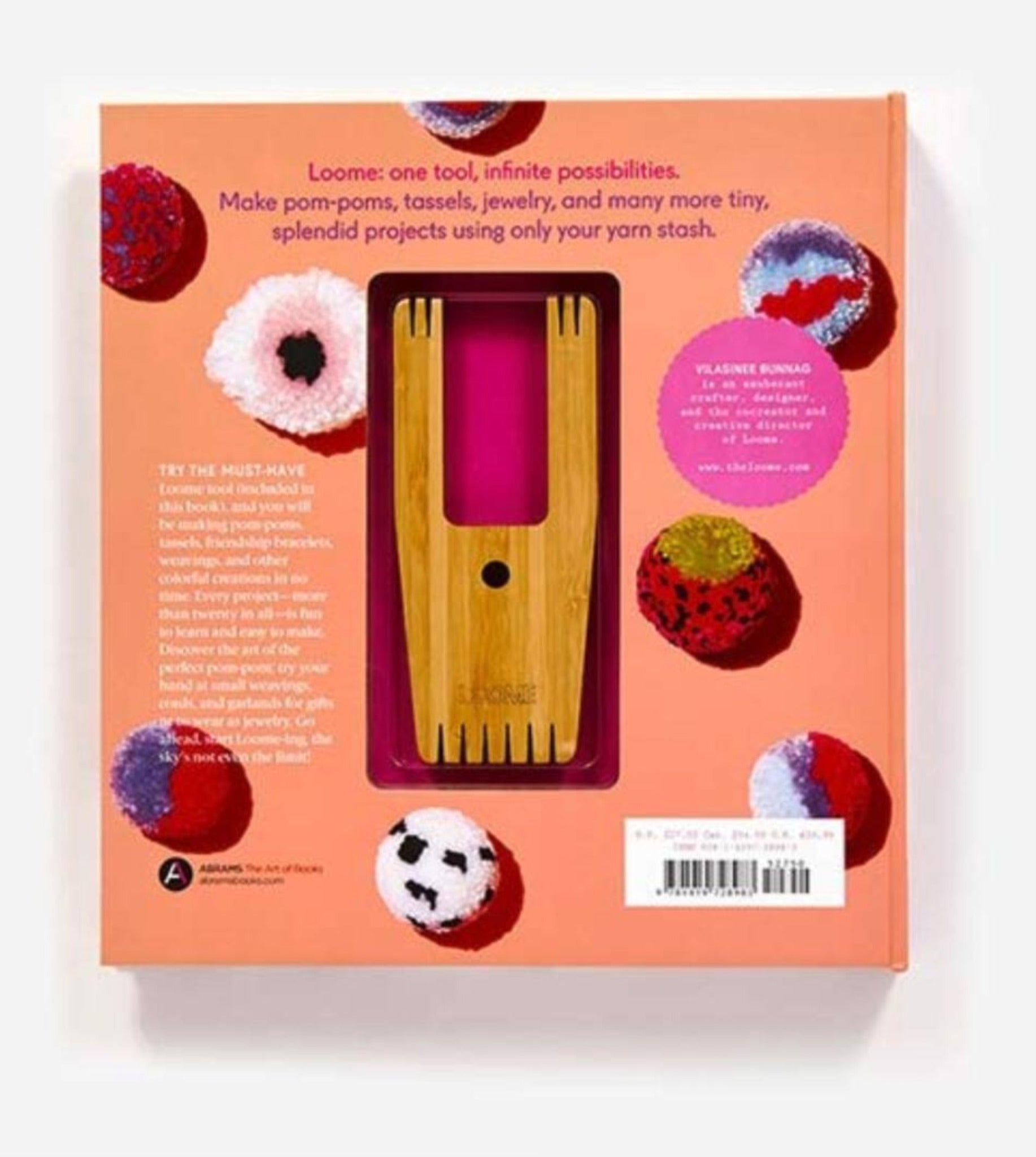 A boxed Loome Party crafting tool set against a peach background. The package features a wooden fork-like device and images of colorful pom-poms. Text on the box highlights its use for creating pom-poms, tassels, jewelry, and other small yarn projects—perfect for stash-buster projects from Abrams - STC Craft.