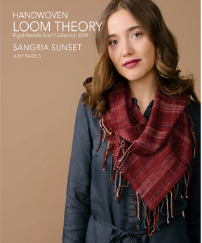 A person with long brown hair is dressed in a dark blue outfit, complemented by a red woven scarf. The text displays "Long Thread Media HANDWOVEN LOOM THEORY Rigid-Heddle Scarf Collection 2019, SANGRIA SUNSET, JUDY PAGELS." The background features a neutral tan color.