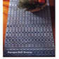 A wooden table is adorned with a blue and white runner from the Handwoven Design Collection #11. This piece, featuring intricate geometric and floral motifs, adds elegance to any setting. The text below reads, "Long Thread Media: Heirloom Table Linens eBook (Printed version).