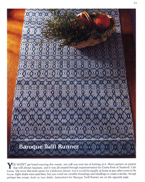 A wooden table is adorned with a blue and white runner from the Handwoven Design Collection #11. This piece, featuring intricate geometric and floral motifs, adds elegance to any setting. The text below reads, "Long Thread Media: Heirloom Table Linens eBook (Printed version).