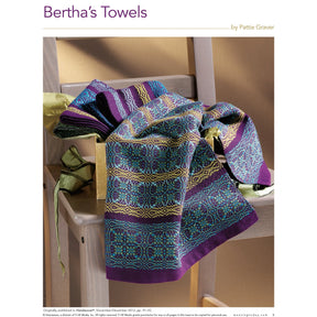 A colorful, intricately patterned towel from Long Thread Media's Handwoven Special Pattern Collection – 5 Towels on 4-Shafts eBook printed copy is draped over a wooden chair. The towel features shades of blue, purple, yellow, and green with geometric and floral designs. The neutral background draws attention to the vibrant fabric. Text reads "Long Thread Media".