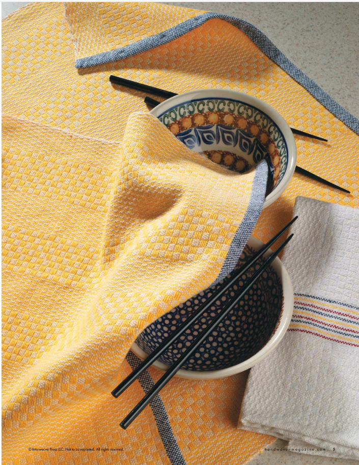 Two intricately patterned bowls are surrounded by black chopsticks, all elegantly draped with a vibrant yellow cloth from the Handwoven Design Collection #18 by Long Thread Media. A white cloth with subtle stripes lies beside the arrangement on a speckled surface, reminiscent of designs found in A Treasury of Towels eBook (Printed version).