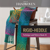 A vibrant woven scarf featuring geometric patterns adorns a stool beside a basket. The text reads, "Best of Handwoven, Rigid Heddle Technique & Pattern Book 3, eBook (Printed version)" by Long Thread Media. In the background, a cup and a book complete the scene.