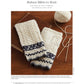 The image depicts a pair of cream-colored knitted mitts with intricate blue patterns, designed by Riina Tomberg and featuring a pattern by Nancy Bush. These mitts are showcased alongside knitting needles and a ball of cream-colored yarn on a brown surface. They can be found in the "PieceWork Presents: Fingerless Mitts for All Seasons – eBook printed copy" by Long Thread Media.