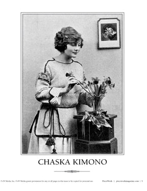 A black and white vintage photograph features a woman arranging flowers in a pot on a small table beside her. She is wearing an intricately detailed knitted sweater, with a framed picture hanging on the wall behind her. The text reads "PieceWork Presents: 7 Captivating Kimonos from 1918 to Crochet eBook – eBook printed copy," by Long Thread Media.