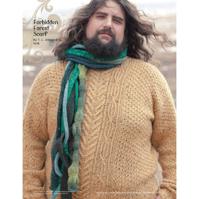 A person with a beard wearing a beige cable-knit sweater and a multicolored, green-hued scarf stands outdoors. The image is featured in the "Magical Knitted Costume Collection – eBook printed copy" by Long Thread Media. In the background, there are faint snowy plains visible.