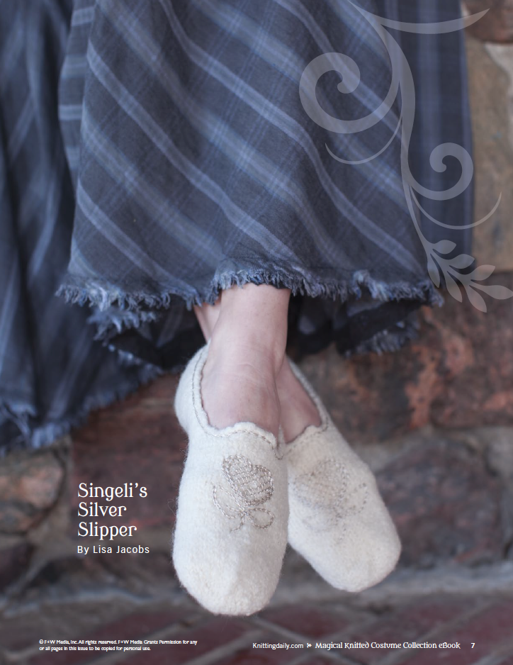 A person wearing cozy knit slippers with floral embroidery is sitting against a stone wall. They are dressed in a long, blue and gray striped skirt. The text on the image reads "Magical Knitted Costume Collection – eBook printed copy by Long Thread Media.