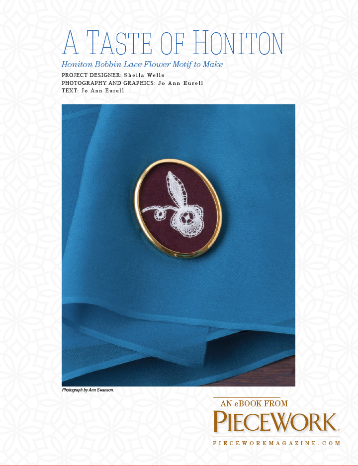 The image displays the cover of an eBook titled "A Taste of Honiton: Honiton Bobbin Lace Flower Motif to Make" published by Long Thread Media. The design showcases a floral motif of Honiton bobbin lace on a red backdrop with a golden edge, positioned against blue fabric.