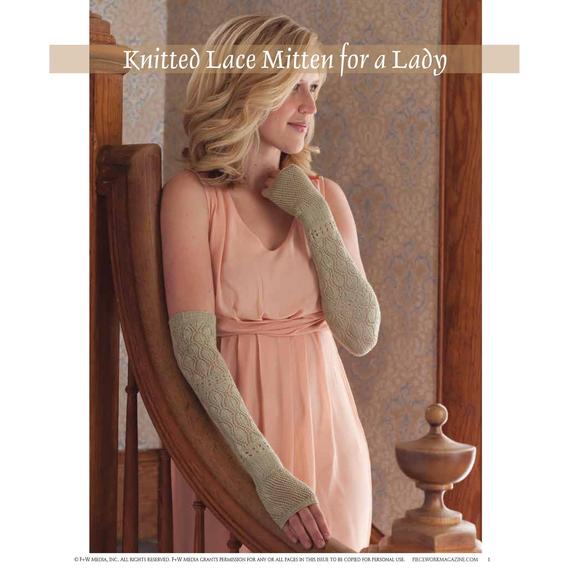 A woman with blonde hair, wearing a sleeveless pink dress, is posing indoors while leaning on a wooden railing. She is showcasing elegant, long light green knitted lace mittens that cover her forearms and extend to her wrists. Text at the top reads "Victorian Lace: 7 Timeless Projects to Knit – eBook printed copy by Long Thread Media.