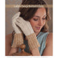 A woman wearing a sleeveless top rests her head on her gloved hands while smiling. The gloves feature a fancy knitted design with intricate patterns, reminiscent of the timeless designs found in Long Thread Media's "Victorian Lace: 7 Timeless Projects to Knit – eBook printed copy." The top part of the gloves is off-white, transitioning to a lacy, textured brown at the wrists.