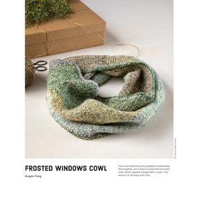 A colorful knitted cowl in gradient shades of green, blue, and beige is displayed on a table. Beside it lie scissors, a spool of green thread, and a brown kraft box. Text at the bottom reads "Frosted Windows Cowl" by Angela Tong, accompanied by a brief description. This project is featured in the "10 Favorite Pin-Loom Projects" Little Looms eBook by Long Thread Media.