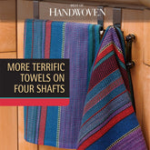 Vibrantly striped towels, crafted using advanced weaving techniques, are displayed against a wooden background. The text "Best of Handwoven: More Terrific Towels on Four Shafts" is featured on a brown backdrop with a red stripe. This printed eBook by Long Thread Media highlights the use of 4-shaft looms for creating these detailed patterns.