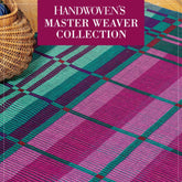 Displayed is a vibrant mat with a plaid pattern in various shades of pink, blue, and green. The top section showcases a red banner with white text reading "Handwoven Master Weaver Series from Long Thread Media." A wicker basket is partially visible on the left.