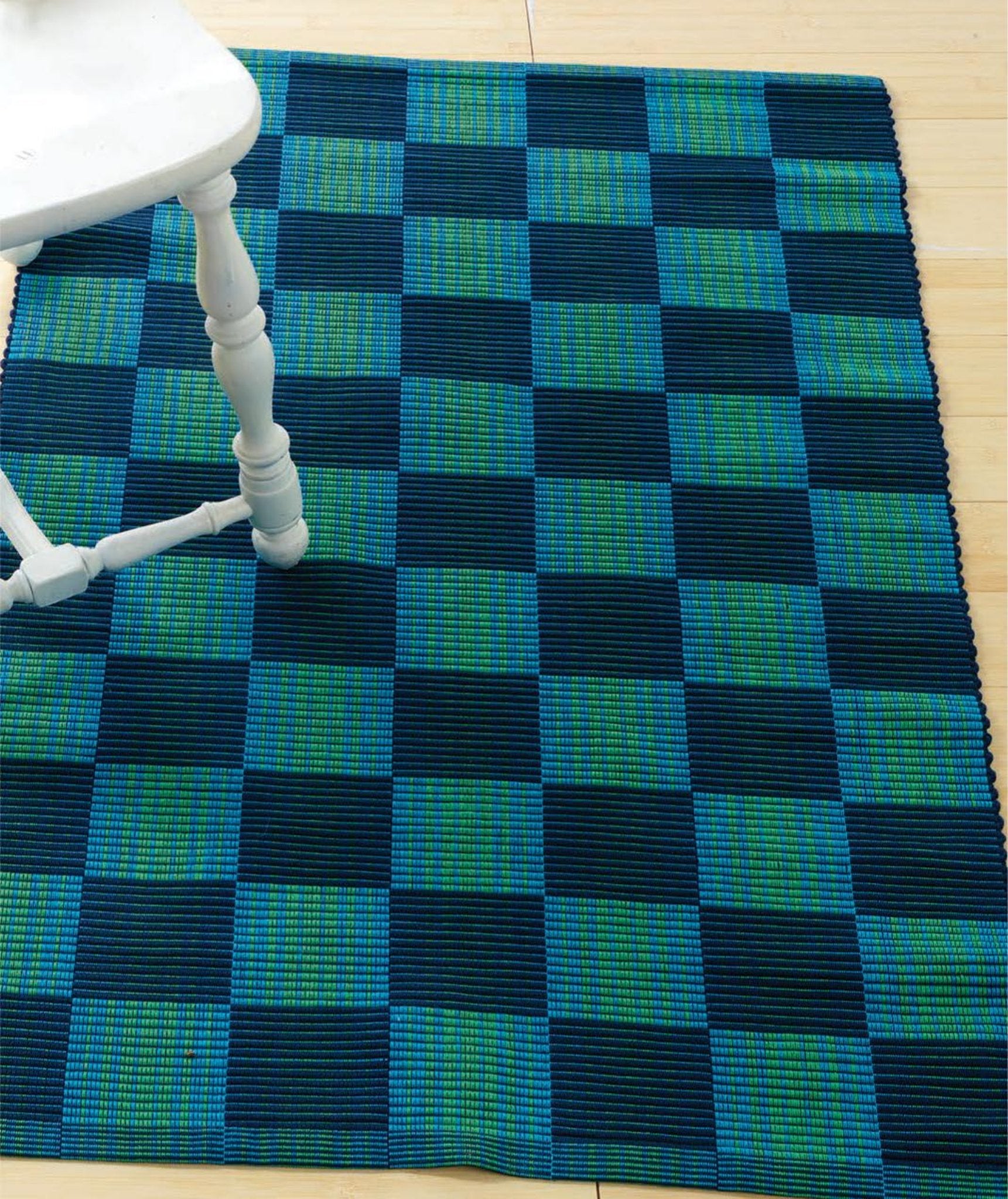 The eBook printed copy of "Handwoven's Master Weaver Collection: Favorite Projects and Lessons from Tom Knisely" by Long Thread Media is placed on a light wooden floor, partially visible in the top left corner.