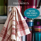 A dish towel with a red and white checkered pattern is draped over a metal handle. In the background, there are vibrant stacked metal containers. The text features "Long Thread Media" and "Best of Handwoven, Top Ten Towels on Four Shafts (Printed Version).