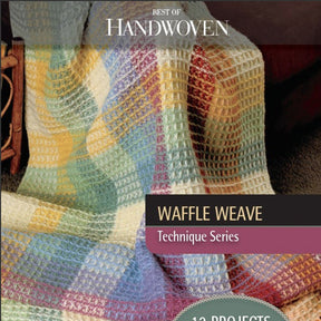 A multicolored waffle weave blanket, elegantly draped over a chair, graces the cover of Long Thread Media's "Best of Handwoven Technique Series: Waffle Weave (Printed Version)," highlighting 12 captivating projects.