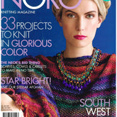 Cover of the "Noro Knitting Magazine Fall/Winter 2017 Issue 11" by Soho Publishing, featuring a woman wearing a multicolored knitted shawl and a beaded necklace. Highlights include "33 Projects to Knit in Glorious Color," "Scarves, Cowls & Capes," "Star Bright! Knit Our Stellar Afghan," and stylish "Southwest Ponchos & Reijanas.