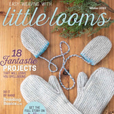 The cover of the "Easy Weaving with Little Looms - Winter/Holiday 2023" issue by Long Thread Media showcases neatly woven gray mittens and a pair of baby's mittens tied together with blue and white braided strings, set against a wooden background adorned with some green foliage. The text highlights 18 weaving projects, including Rigid Heddle techniques.