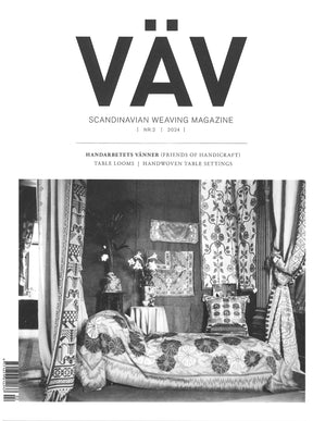 The black and white cover of "VÄV Magasinet 2/24" from VÄV Magazine features an interior adorned with intricate woven textiles, including medieval wool fabrics used in curtains, a bedspread, and cushions. A small table with a flower vase adds to the scene.